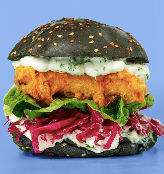 Fish and chip shop latest food trends is the activated charcoal fish fillet burger