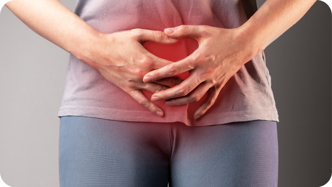 Person holding their stomach, with a red glow under their hands to indicate a pain